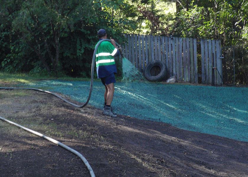 person spraying hydromulch solution
